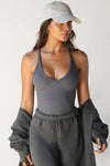 Front view of model posing in the fitted stretchy amoke flexrib V Neck Racerback Tank with a v neckline and thin straps
