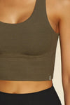 Close up detail front view of model posing in the fitted stretchy cropped woodland flexrib Varsity Tank Bra with a scoop neckline