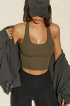Front view of model posing in the fitted stretchy cropped woodland flexrib Varsity Tank Bra with a scoop neckline