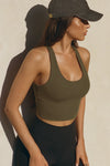 Side view of model posing in the fitted stretchy cropped woodland flexrib Varsity Tank Bra with a scoop neckline