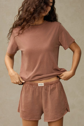 Front view of model posing in the tobacco stripe classic cotton Vintage Tee with a crew neckline and relaxed silhouette