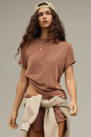 Front view of model posing in the tobacco stripe classic cotton Vintage Tee with a crew neckline and relaxed silhouette