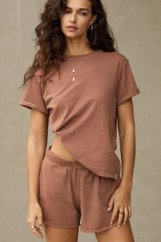 Front view of model posing in the tobacco stripe classic cotton Vintage Tee with a crew neckline and relaxed silhouette
