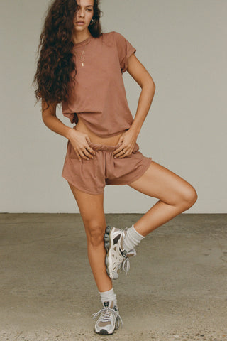 Full body front view of model posing in the tobacco stripe classic cotton Vintage Tee with a crew neckline and relaxed silhouette