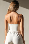 Back view of model posing in the fitted stretchy chalk modal Cinched Cami tank with a sweetheart neckline, gathered detail at the bust and delicate corded straps