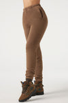 Front view of model from the waist down posing in the tapered cocoa french terry Empire Jogger with side pockets and an elastic waistband and ankle cuffs