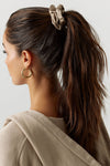 Back view of model wearing the fawn Silk Scrunchie hair tie around her hair in a high ponytail