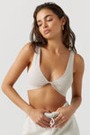 Front view of model posing in the fitted and stretchy sueded yuma Smoothing Twist Bra top with a plunging neckline and twist detail at the center bust
