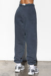 Back view of model from the waist down wearing the oversized loose fit washed navy french terry Oversized Jogger with an elastic waistband and ankle cuffs