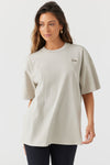 Front view of model posing in the relaxed fit fog cotton Oversized Crew Tee with a crew neckline and joah brown logo patch on the upper left side