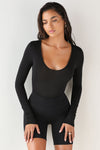 Front view of model wearing the fitted soft black modal Scoop Neck Long Sleeve top with a deep scoop neckline and fitted sleeves