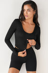 Front view of model wearing the fitted soft black modal Scoop Neck Long Sleeve top with a deep scoop neckline and fitted sleeves