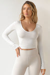 Front view of model wearing the fitted soft chalk modal Scoop Neck Long Sleeve top with a deep scoop neckline and fitted sleeves