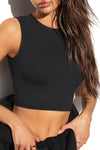 Close up detail front view of model posing in the fitted and cropped contouring sueded onyx Second Skin Tank with a high crew neckline