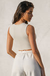 Back view of model posing in the fitted and cropped contouring sueded yuma Second Skin Tank with a high crew neckline