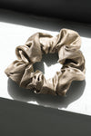 Flat lay view of the fawn Silk Scrunchie hair tie