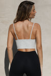 Back view of model posing in the fitted and stretchy pearl grey flexrib Strappy Crop Tank with thin straps and a low back